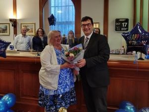 Chief executive Steven Jones presents a bouquet to Stafford Railway Building Society member Shirley Butler