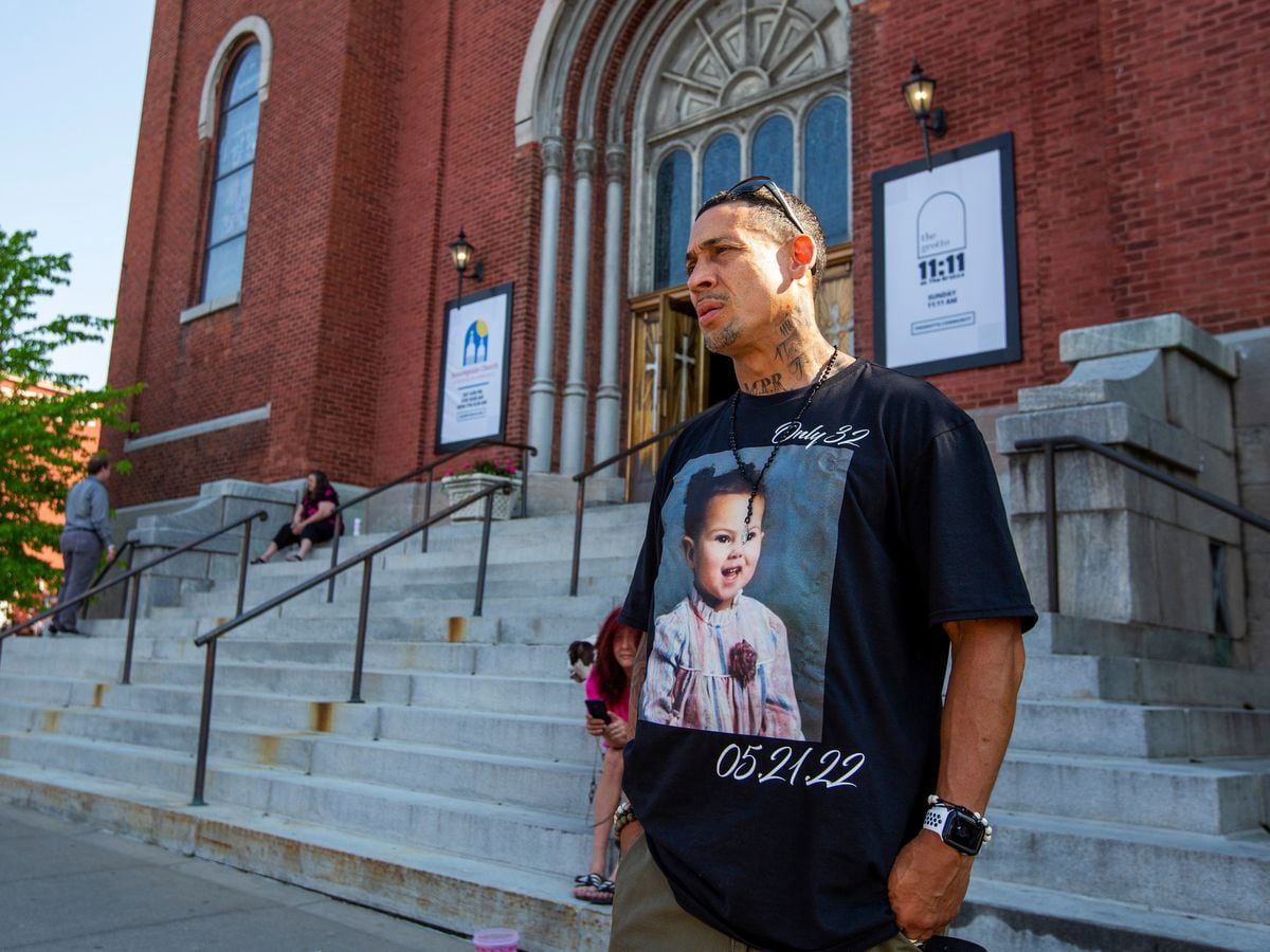 Enrique Owens, a cousin of Roberta Drury, wears a T-shirt with her photograph on it before her funeral service on Saturday May 21 2022 (Lauren Petracca/AP)