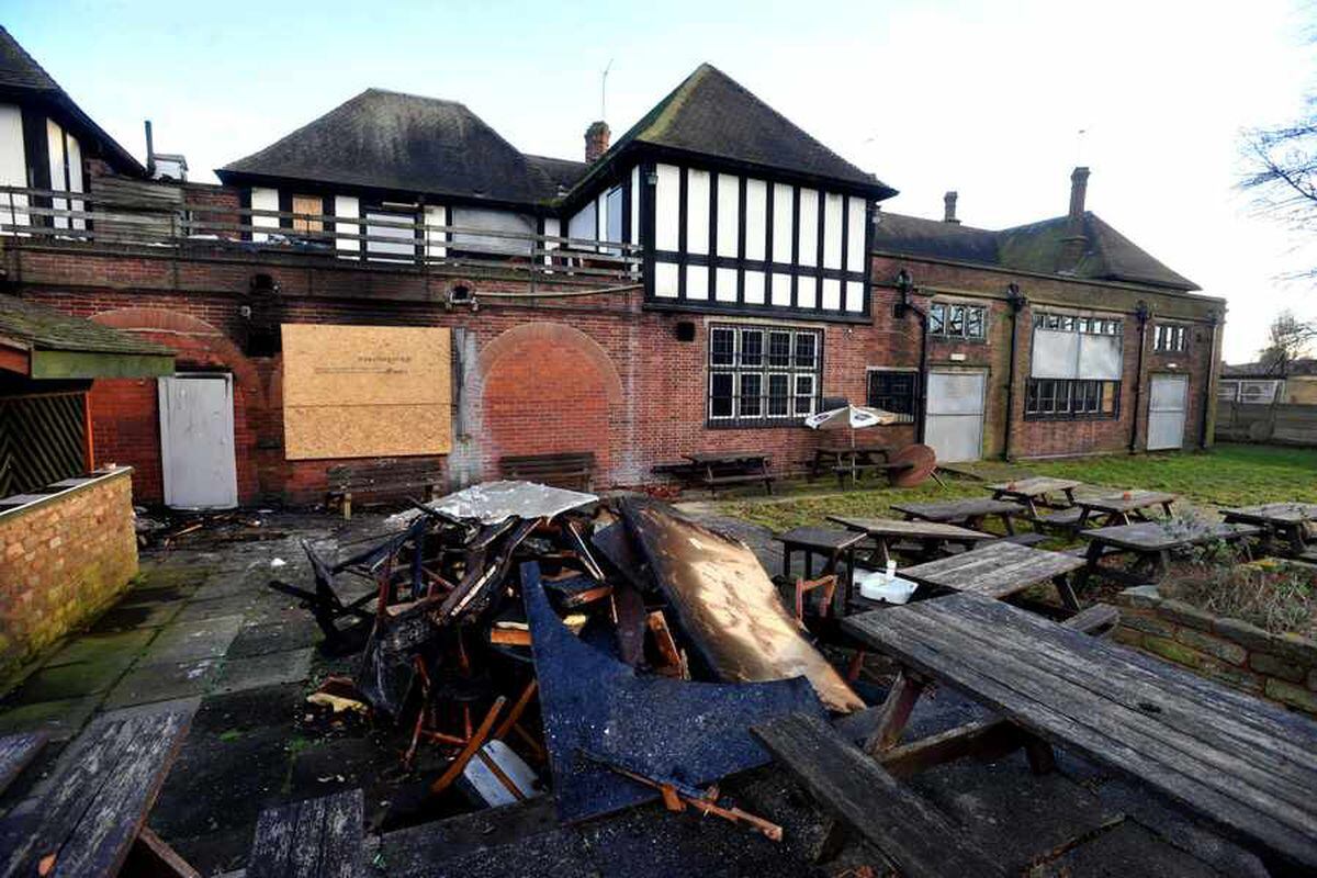 The fire-ravaged exterior and garden of the Bushbury Arms in 2013