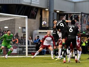 Conor Wilkinson rises as he goes for goal