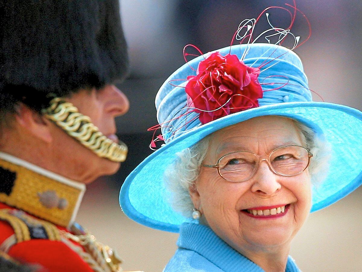 Queen Elizabeth II smiling with the Duke of Edinburgh on Horse Guards Parade during the annual Trooping the Colour parade in 2009