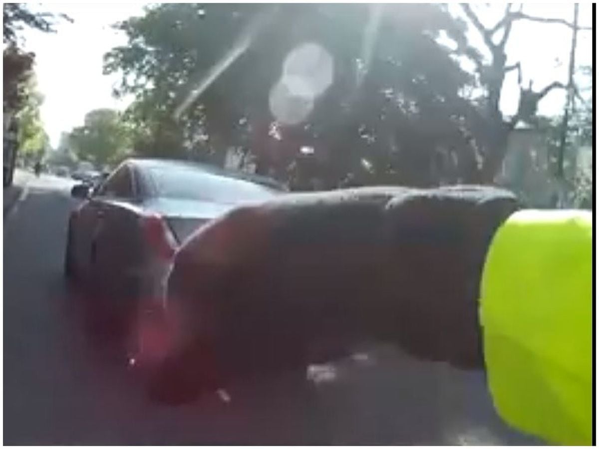 The cyclist remonstrates as the car driver is captured on camera