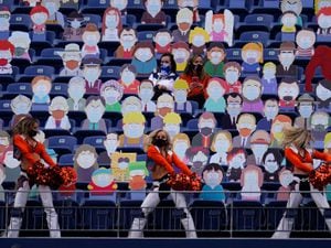 Denver Broncos cheerleaders perform as two fans sit among cardboard characters from the show South Park during the first half of an NFL football game against the Tampa Bay Buccaneers, Sunday, Sept. 27, 2020, in Denver