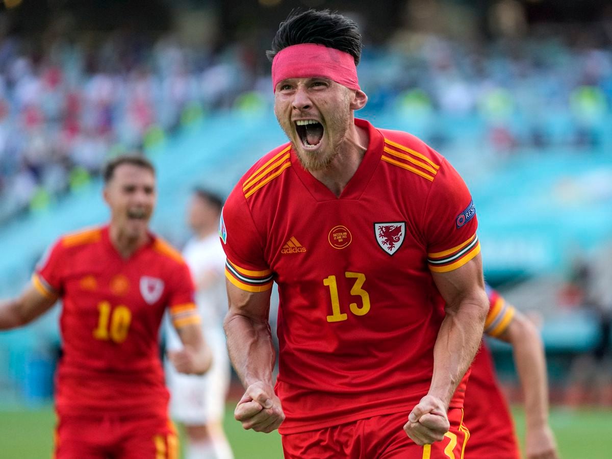 Wales' Kieffer Moore celebrates after scoring his side's opening goal during the Euro 2020 soccer championship group A match between Wales and Switzerland, at the Baku Olympic stadium, in Baku, Azerbaijan, Saturday, June 12, 2021. (AP Photo/Darko Vojinovic, Pool).