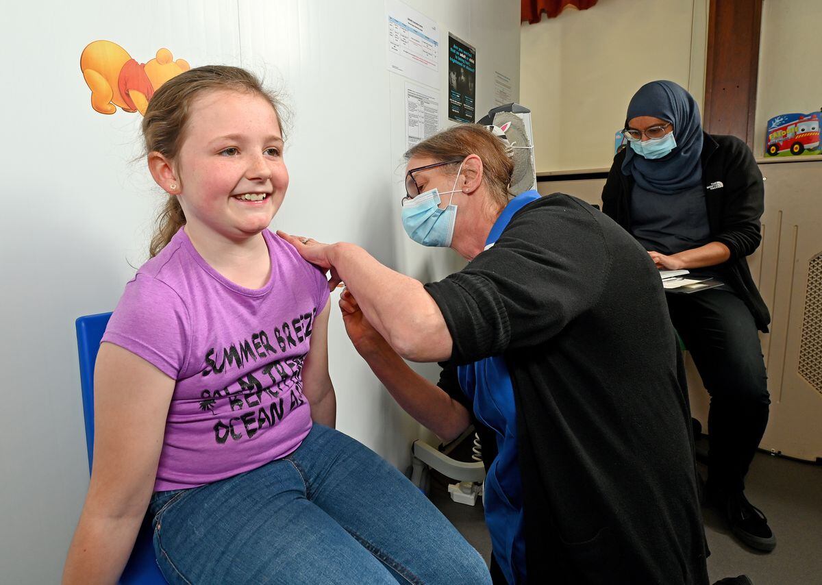 Charlotte Sheppard receives her vaccination jab from nurse Pauline Roberts