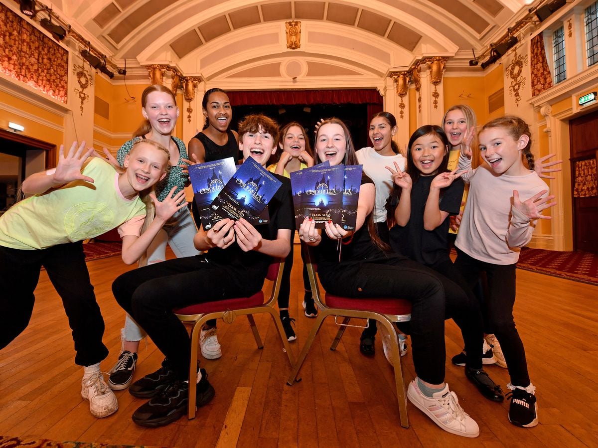 Nate Wallace and Jessica Neill, both seated, and fellow members of the juvenile ensemble, look forward their performances in Cinderella at Sutton Coldfield Town Hall 