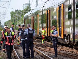 Police officers standing in front of a regional train in Herzogenrath, Germany