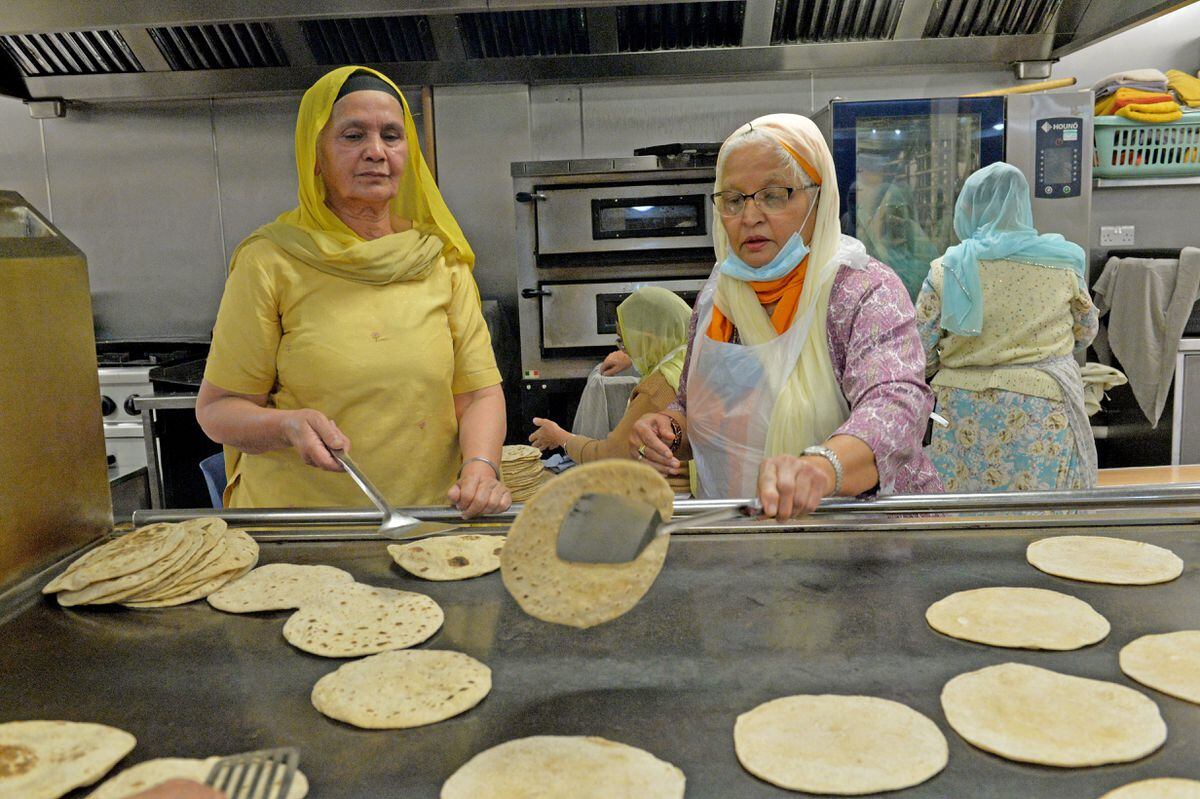Some of the volunteers at the Langar hall prepare and cook rotis