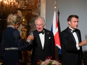 The King shares a toast with Brigitte Macron and her husband