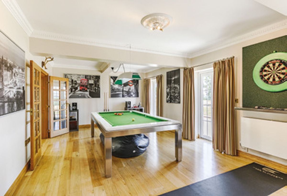A games room includes a snooker table and dart board