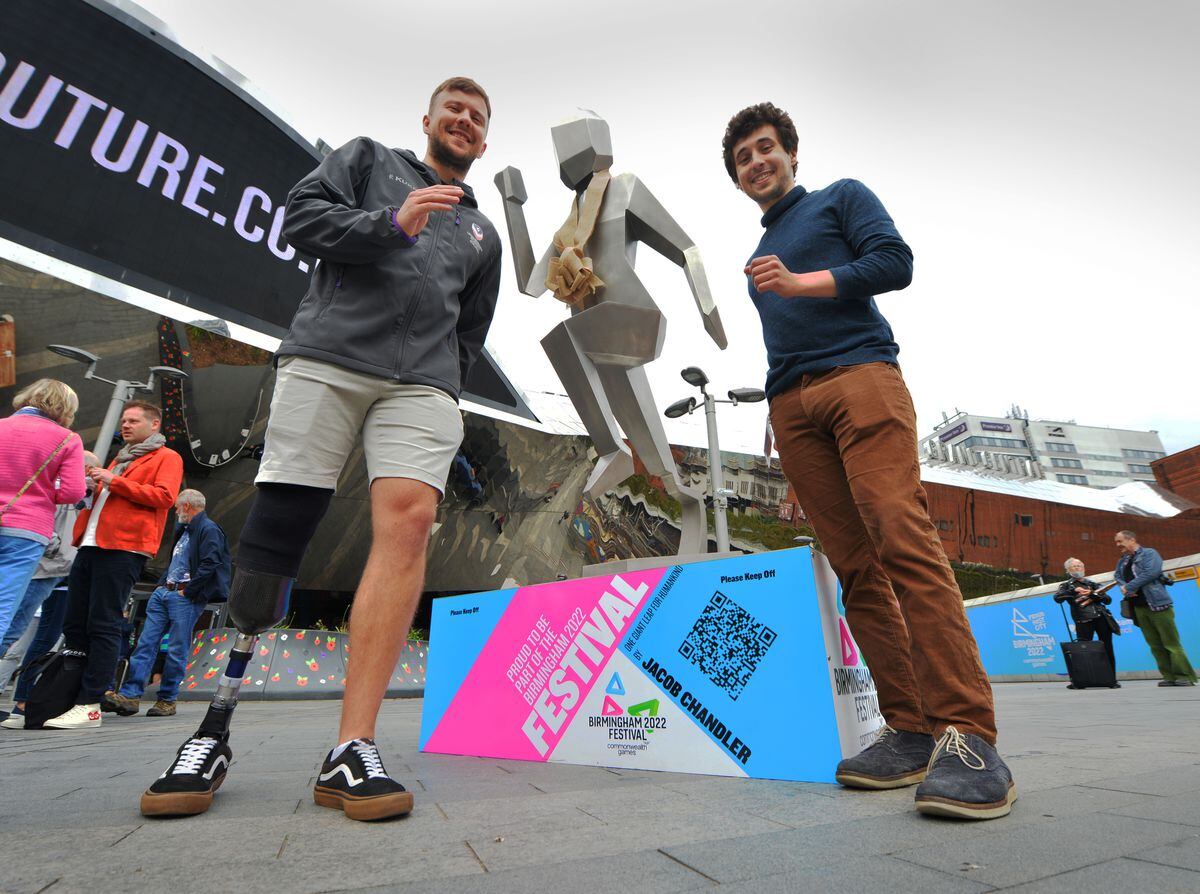 Ben Pearson and Jacob Chandler pose next to the statue at the unveiling ceremony in Birmingham