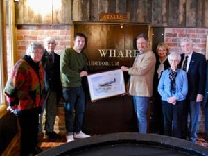 CWT trustee Leo Capernaros at the entrance to Crown Wharf Theatre with Star of Stone Spitfire Group including artist Charles O'Neill and group lead Geoff Berriman