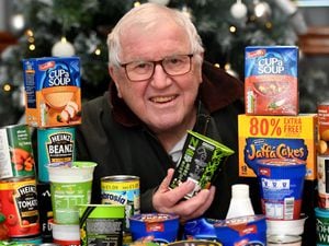 Chairman of the supporters trust, Trevor Reece, at Walsall FC with some of the donated food for the food bank