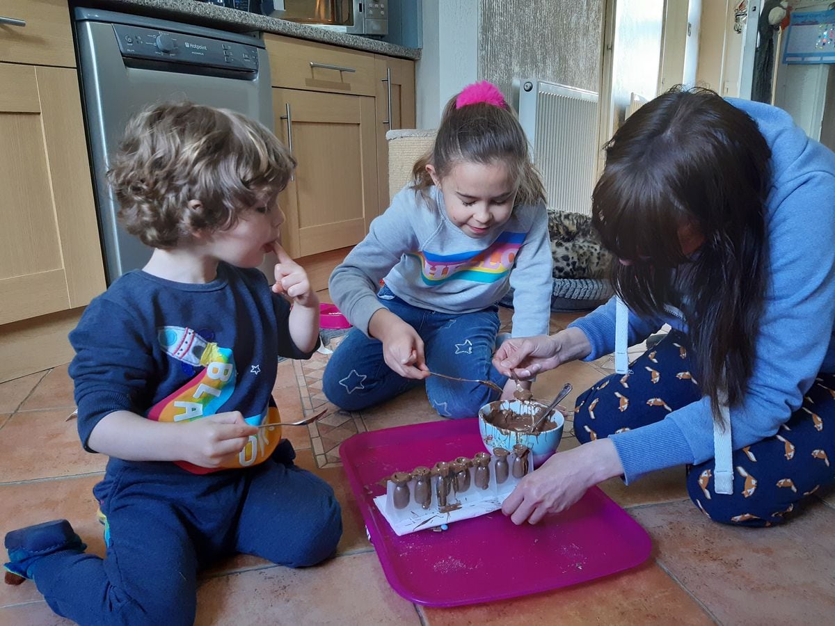 Sarah Thursfield, daughter Freya, aged 9 and son Ted, aged 2, making chocolate lollies in the kitchen