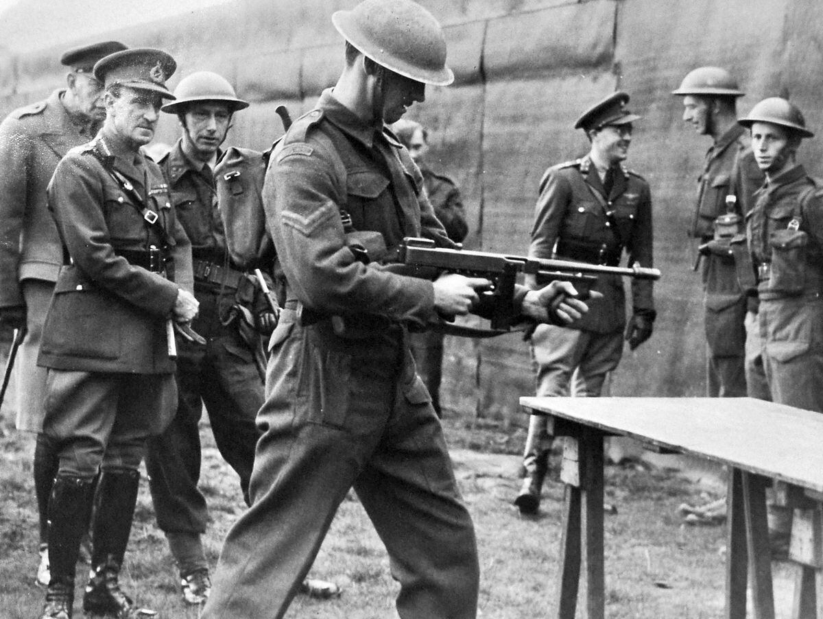  Lieutenant General Paget (left) watching a Dutch soldier demonstrating a Tommy gun at the Dutch military camp at Wrottesley Park, Wolverhampton, in December 1942.