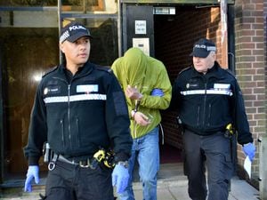 Police making an arrest in a series of dawn raids relating to football hooliganism in 2015