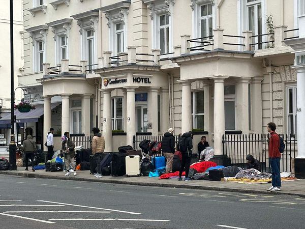 Asylum seekers outside a hotel in Westminster