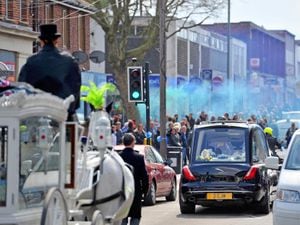 The funeral procession for baby Ciaran Morris in Brownhills High Street. A blue flare is let off.