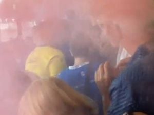 Footage uploaded to Twitter by @AnuMCFC purportedly shows red smoke in the stands.