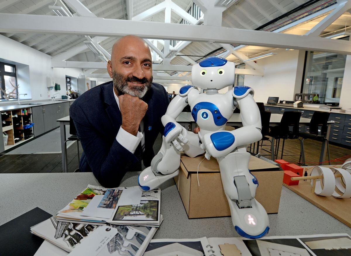 Principal Av Gill with Clarke the robot