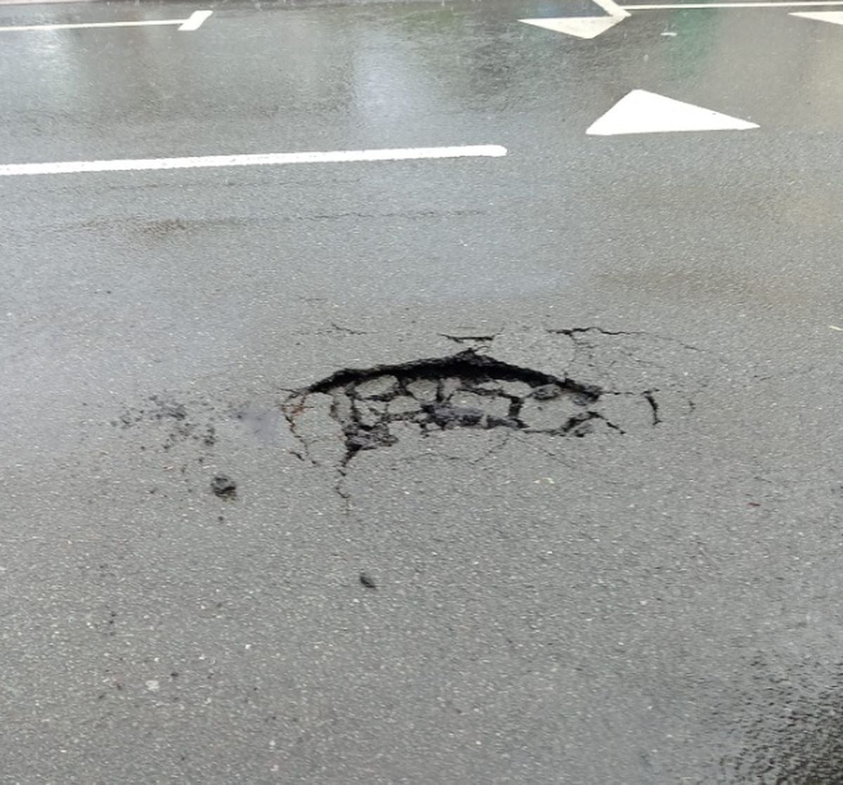 A hole caused by heavy rain in Redhall Road 