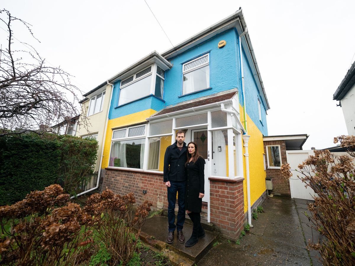 Rend and Michael Platings outside their painted home