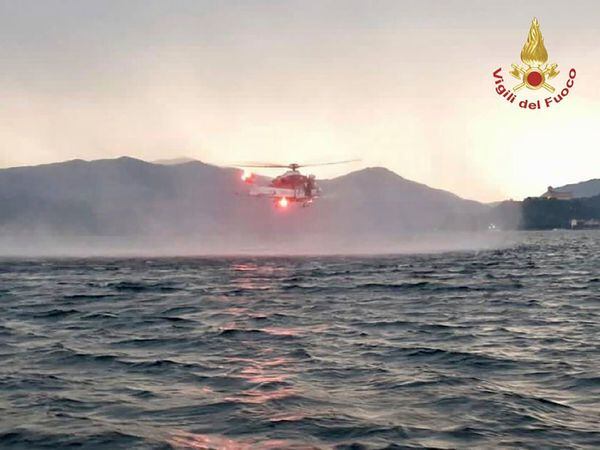 In this image released by the Italian firefighters a helicopter search for missing after a tourist boat capsized in a storm on Italy’s Lago Maggiore in the northern Lombardy region, Sunday, May 28, 2023, with at least one person confirmed dead.