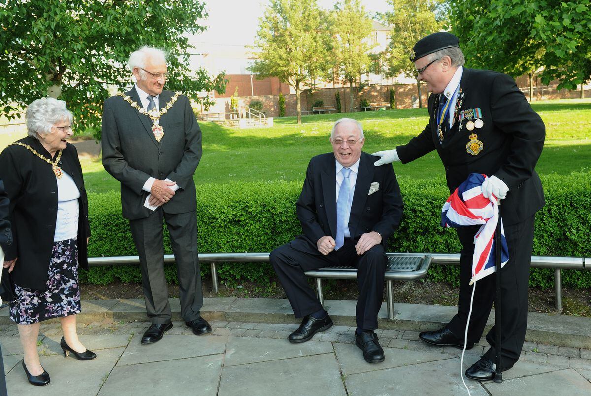 Roy Richardson takes a seat on the bench named in his honour at Dudley Cenotaph