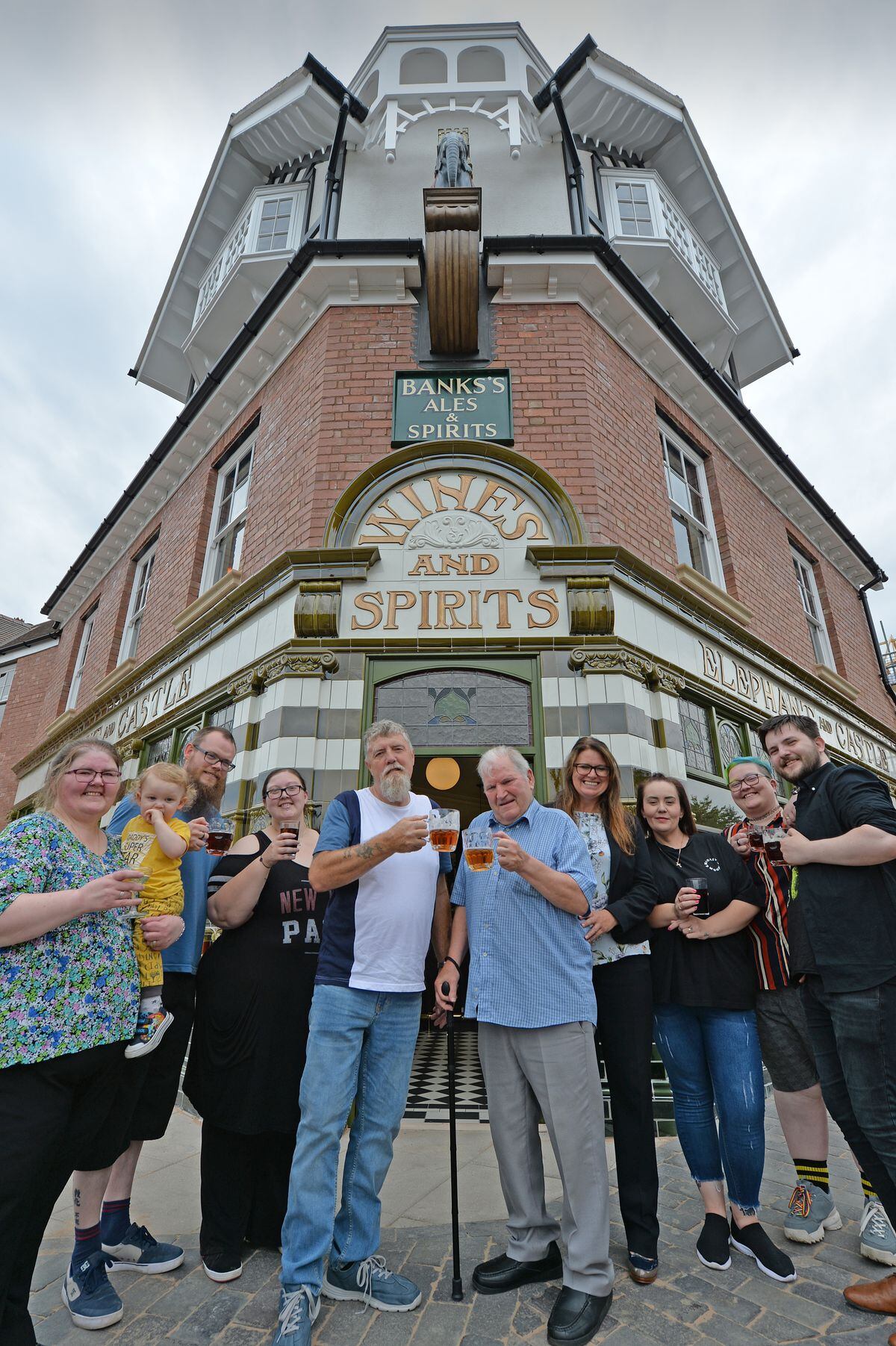 Toasting the pub's good fortune are (front center left) Roy Mincher and his family who lived in the pub in the 1970s and (front right) former owner 1978-79 John Purchase