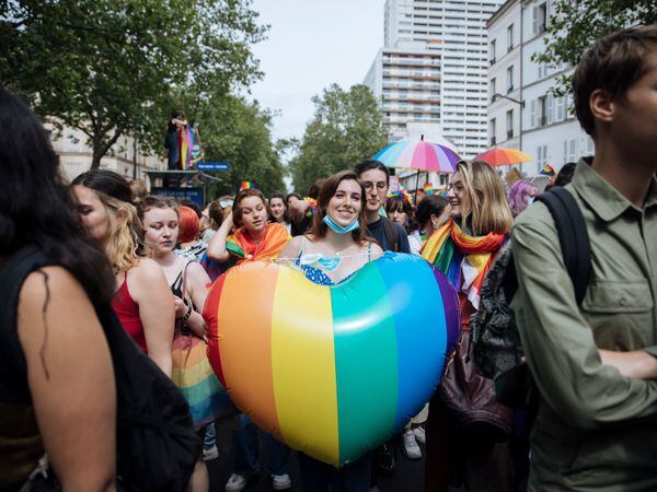 A participant holds a rainbow heart during the annual Gay Pride march in Paris last year