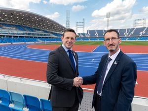Dom Olliff shakes hands with Dave Wagg as the stadium handover is completed