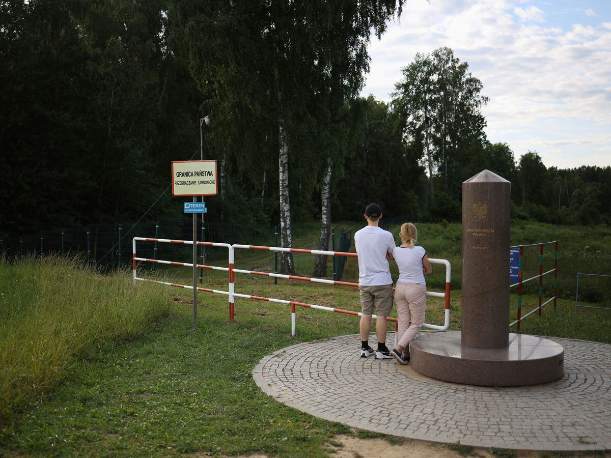 People visit the area of tripoint marking the place where borders of Poland, Lithuania and Russia’s Kaliningrad Oblast meet, in Zerdziny, Poland