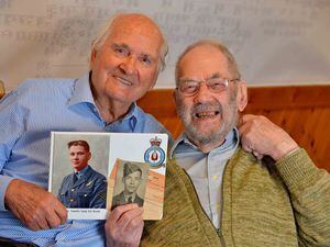 Ron and Roy Tomlin hold photographs of themselves from their RAF days