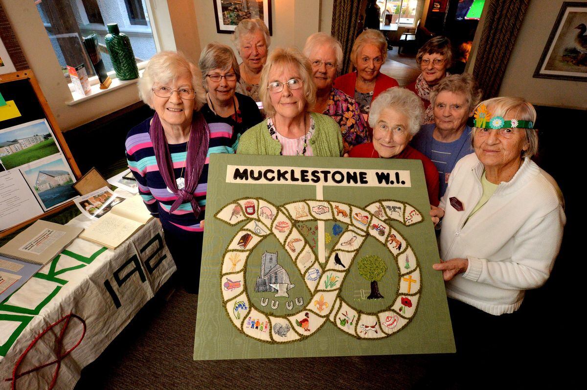 Mucklestone WI. In the middle in green is President: Ruth Lloyd and with her in no particular order is: Sandra Pearce, Margaret Capper, Doreen Brassington, Sue Simmons, P Bourne, Ann McCullagh, Joan Horton, Monique Atkins and Liz Vallings