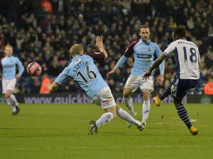 Saido Berahino of West Bromwich Albion shoots and scores his third goal .