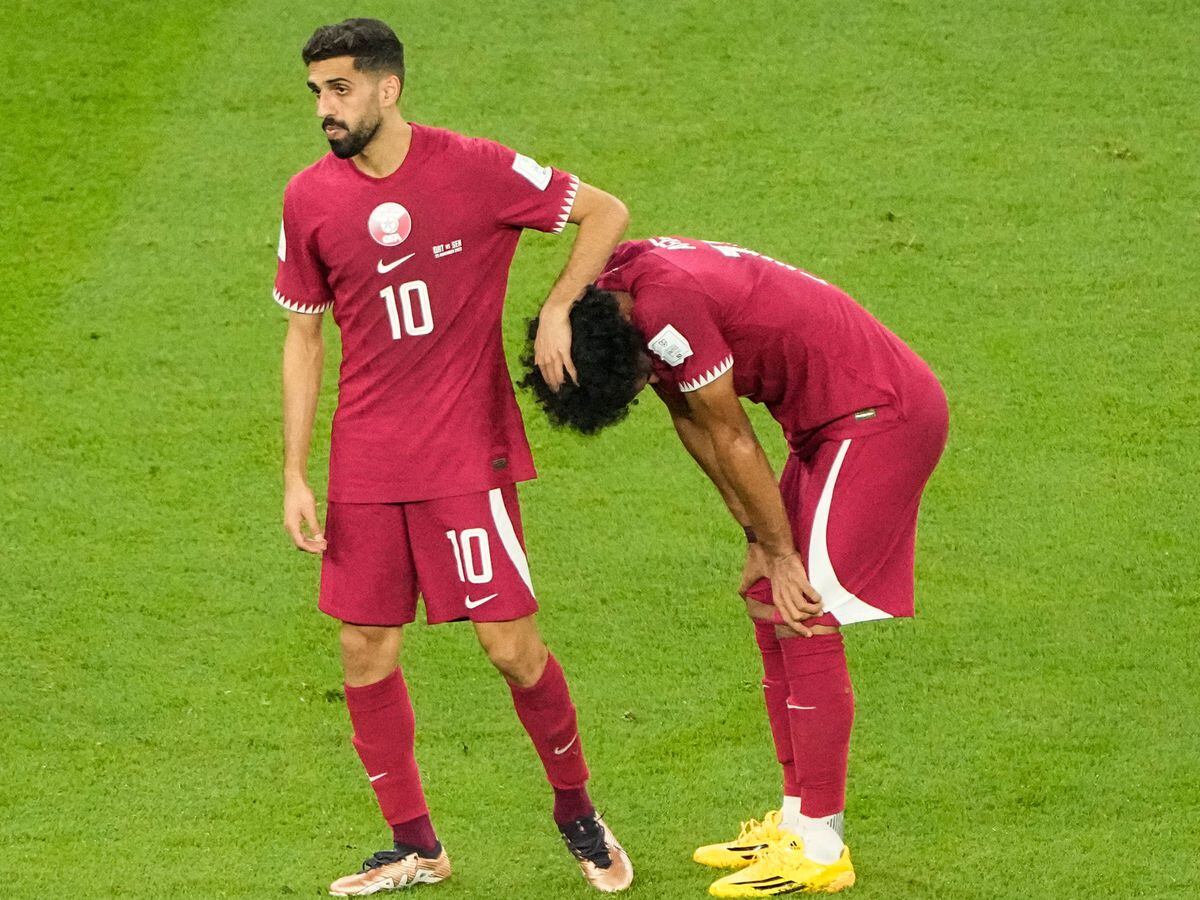 Qatar’s Hassan Al-Haydos (left) and Akram Afif (right) react after defeat to Senegal