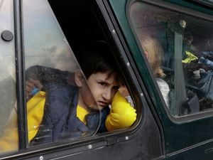 An ethnic Armenian boy from Nagorno-Karabakh looks on from a car upon arrival in Armeniaâs Goris