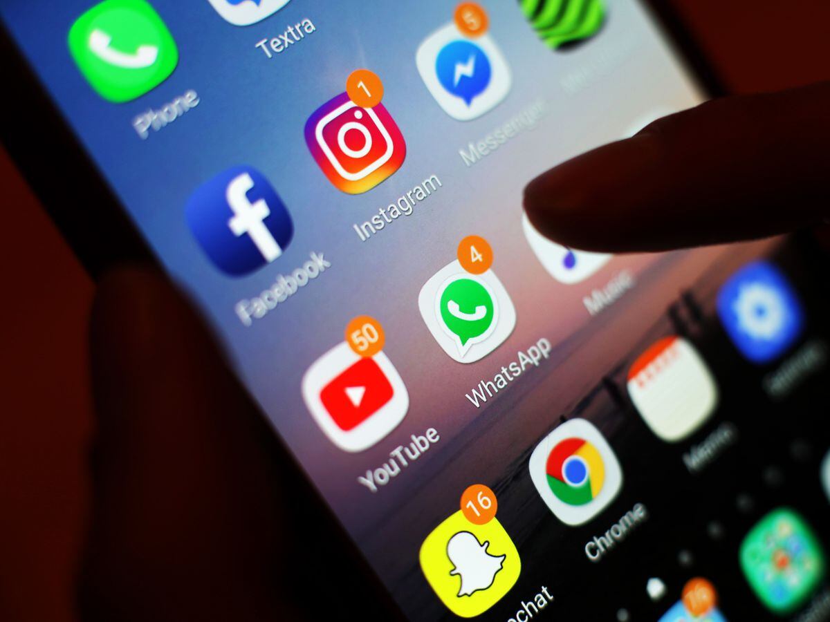 The icons of social media apps, including Facebook, Instagram, YouTube and WhatsApp, are displayed on a mobile phone screen, in London..