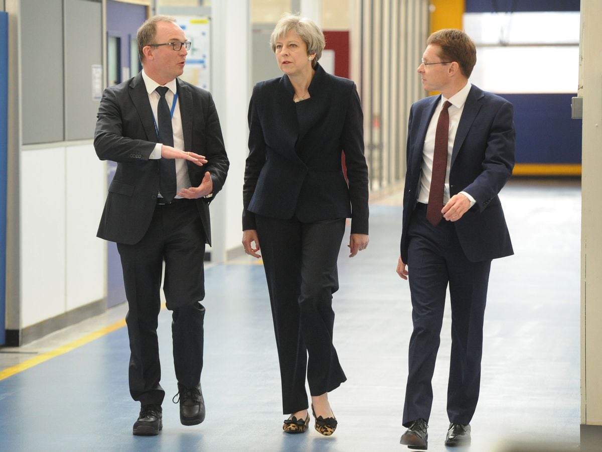 Theresa May, with, left UTC Aerospace general manager Robert Hupfer, and, right, West Midlands Mayor Andy Street, during her visit