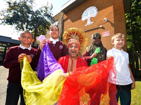 Sohan Kailey with pupils, at his former school West Park Primary