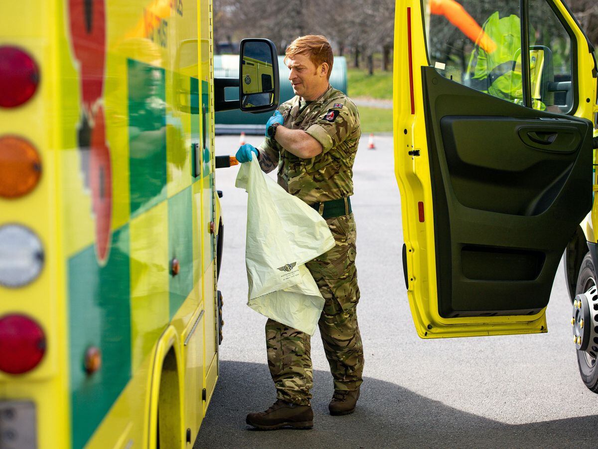 A soldier between two ambulances
