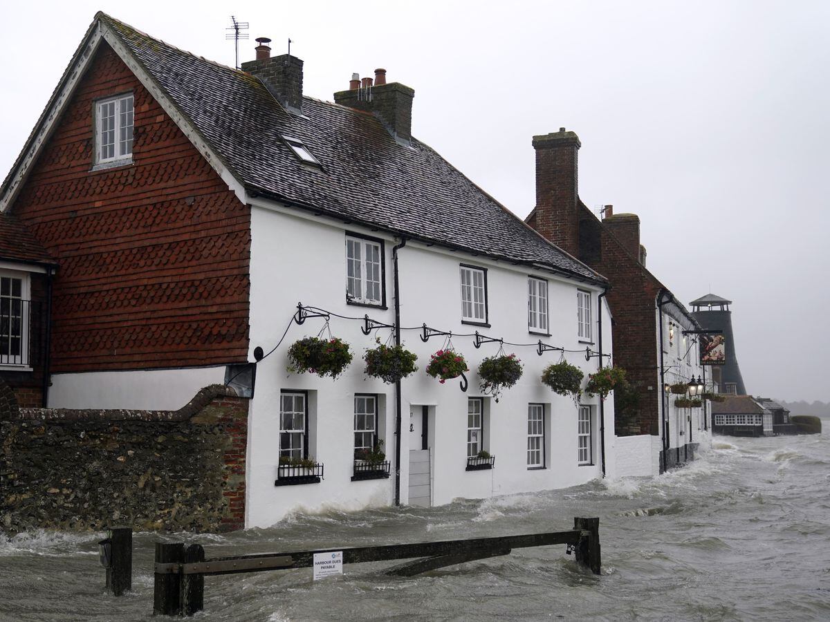 Sea water floods the shore line after high tide in Langstone, Hampshire