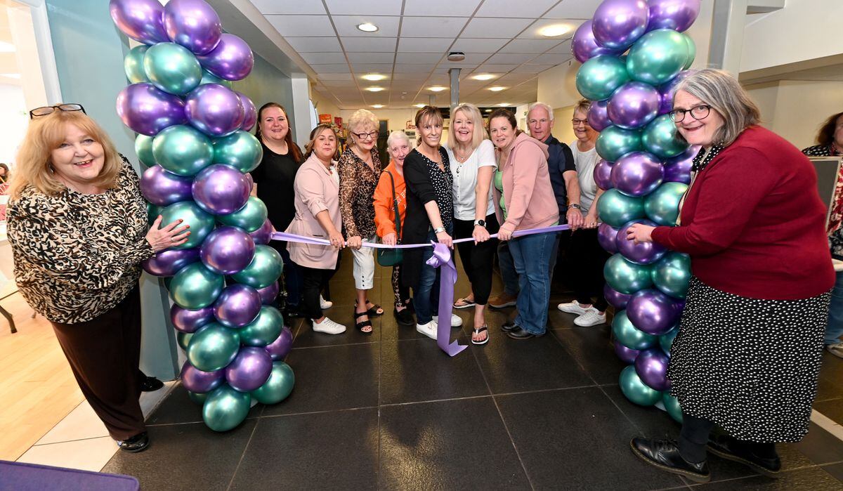 Centre manager Denise Robins (left) with Councillor Louise Miles (right) and volunteers as they cut the ribbon