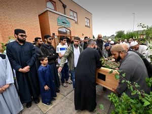 Members of the mosque set up Alomgir Hussain's coffin outside the mosque