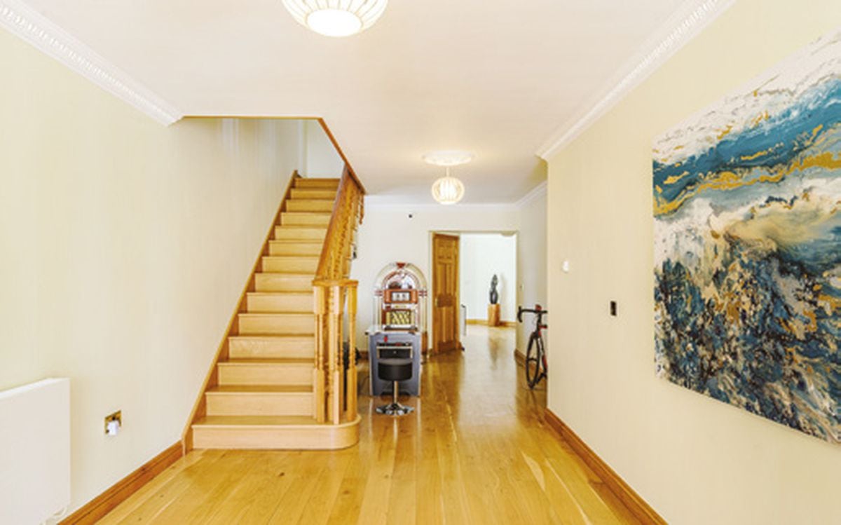 The spacious hallway which has oak flooring throughout