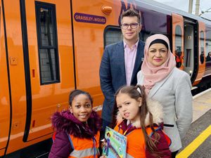 West Midlands Railway customer experience director Jonny Wiseman, head teacher Sharifan Nasa and schoolchildren with the Graiseley Wolves train