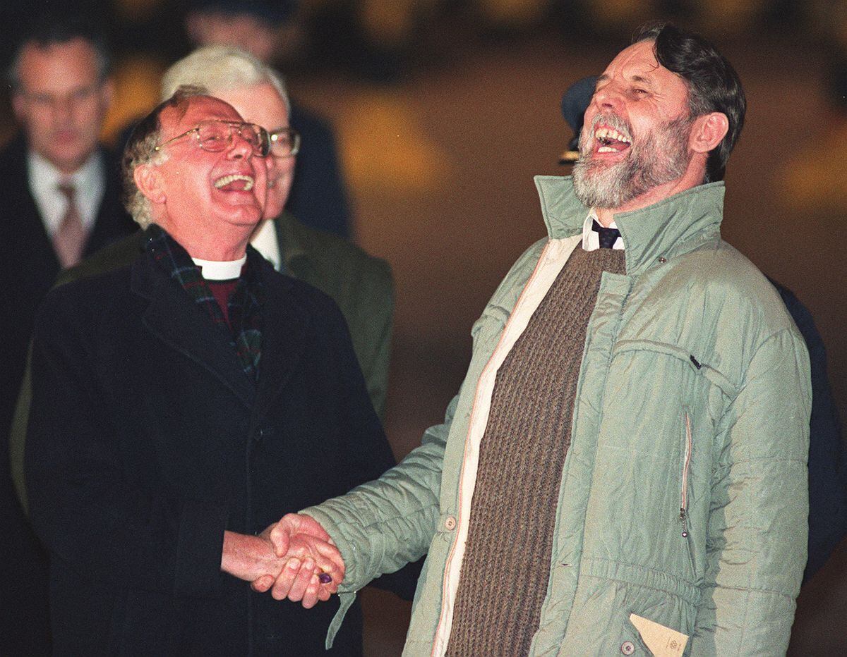 Former Archbishop of Canterbury Lord Runcie (left) sharing a joke with his special envoy Terry Waite upon Waite's release in November, 1991