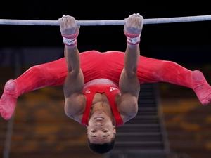 Joe Fraser, of Britain, performs on the horizontal bar during the men's artistic gymnastic qualifications at the 2020 Summer Olympics, Saturday, July 24, 2021, in Tokyo. (AP Photo/Gregory Bull).