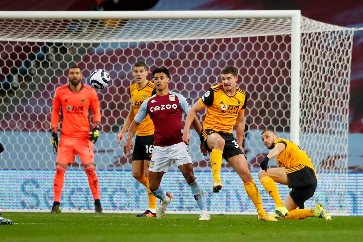 Leander Dendoncker of Wolverhampton Wanderers clears the ball ahead of Ollie Watkins of Aston Villa (AMA)