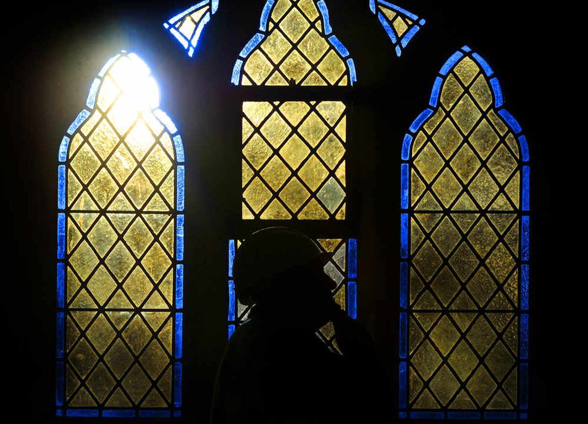 Site manager, Andy Hutchings, views one of the new windows at the restored Lye and Wollescote Cemetery Chapels, Stourbridge